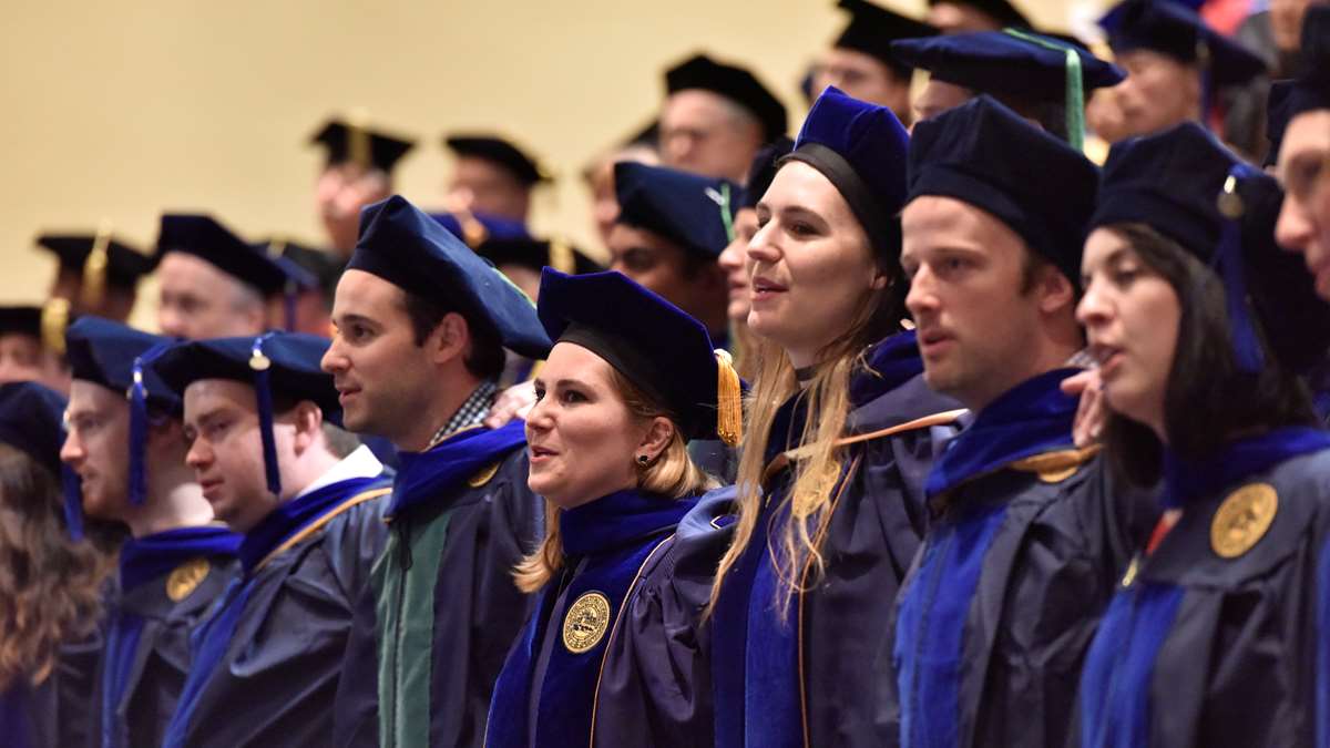 Students pose together at the end of a graduation ceremony in May 2017.
