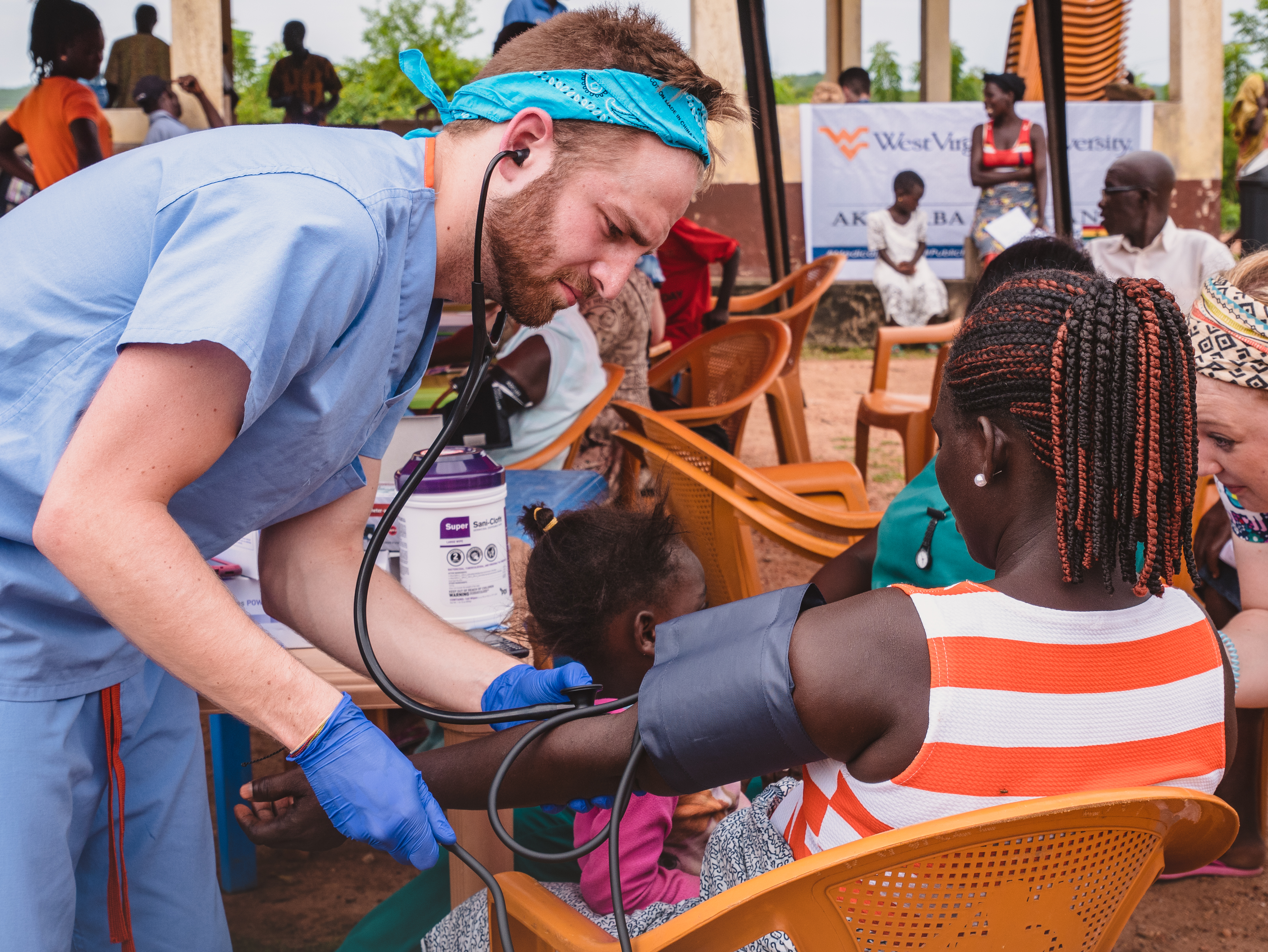 A WVU student performs a procedure on a patient.