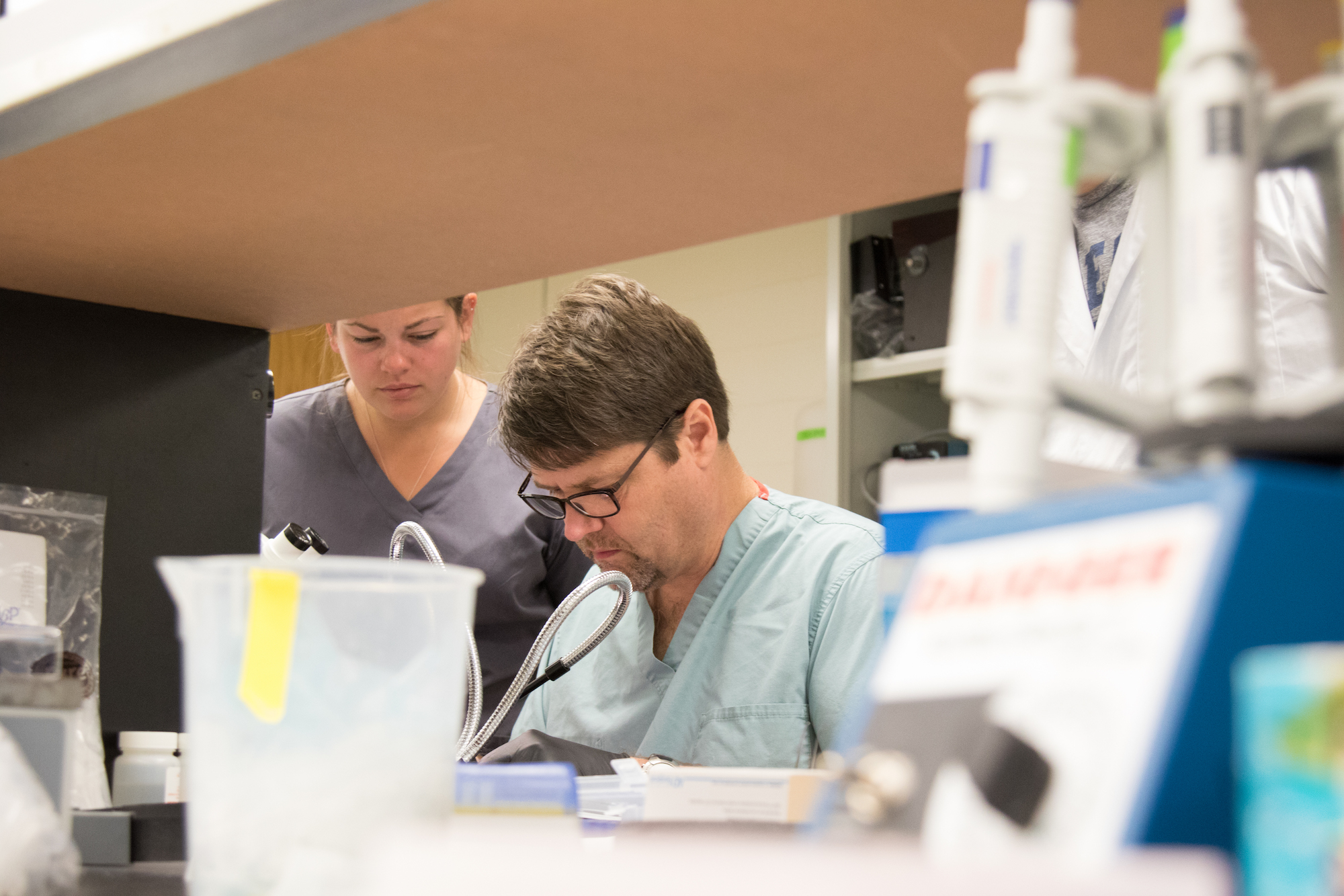 A researcher and faculty member conduct research.